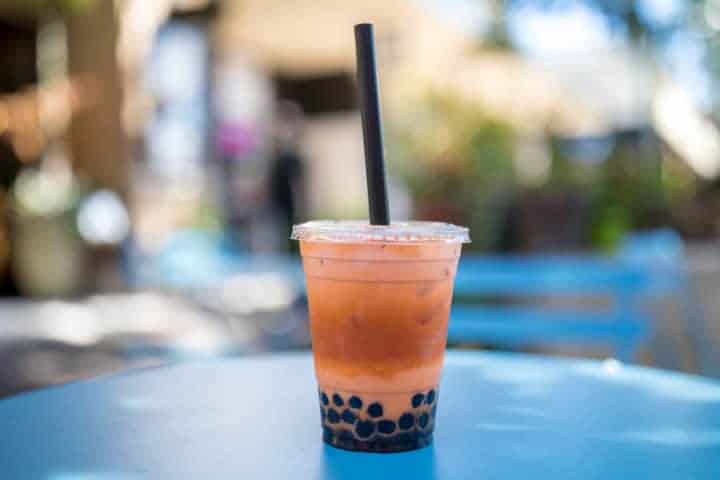 bubble tea is an iced tea that has large tapioca pearls in the bottom of the cup