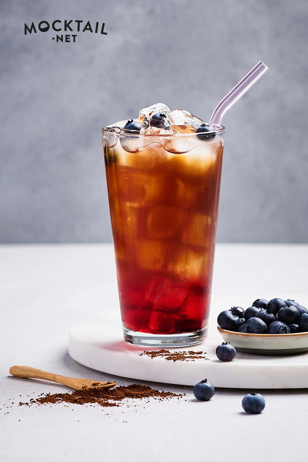 Add the blueberry syrup and cold coffee to a tall glass.